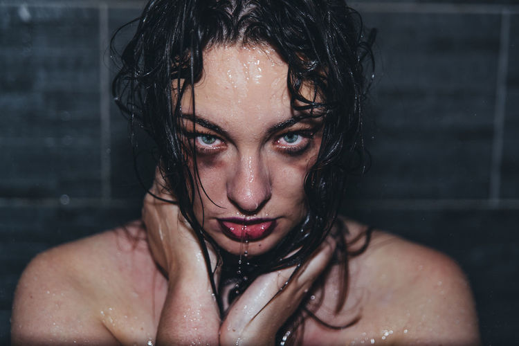 Portrait of beautiful woman with wet hair in bathroom