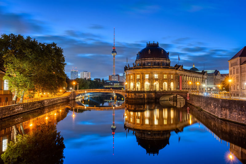 The bode-museum and the television tower reflected in the river spree in berlin at night