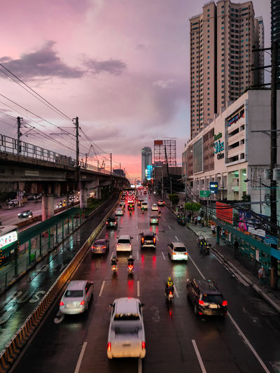 Traffic on city street during sunset