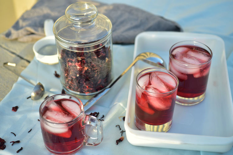 Cold summer ice tea made with hibiscus flower petals