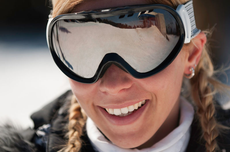 Close-up portrait of smiling mid adult woman wearing ski goggles