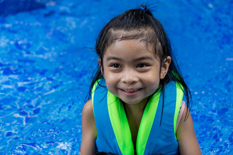 Portrait of smiling girl in swimming pool