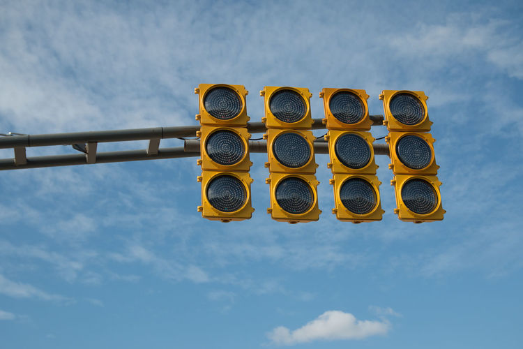 Low angle view of traffic light against sky