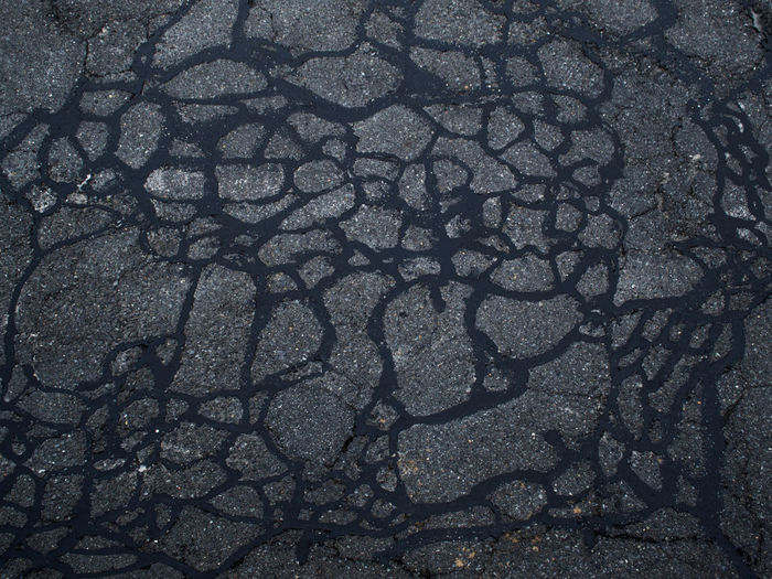 High angle view of cracked land on street