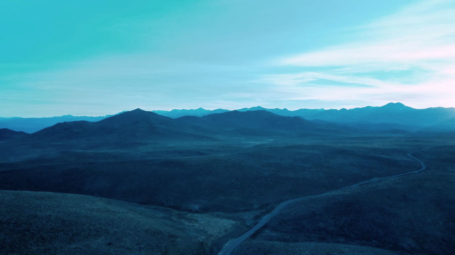 Scenic view of mountains against cloudy sky