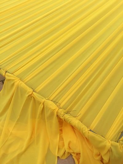 Close-up of yellow clothes drying