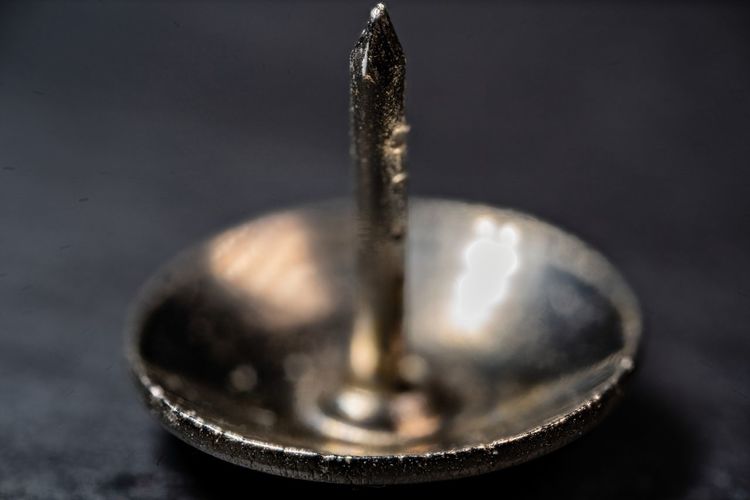 A macro photography of a metal pushpin