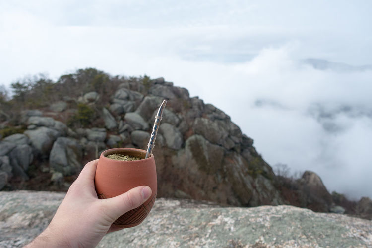 Close-up of hand holding yerba mate