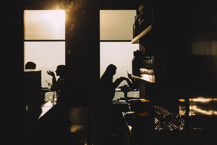 Silhouette of people in caf