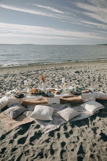 Ramadan food on the scenic view of beach against sky