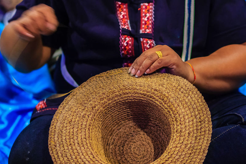 Close-up of woman hands making hat