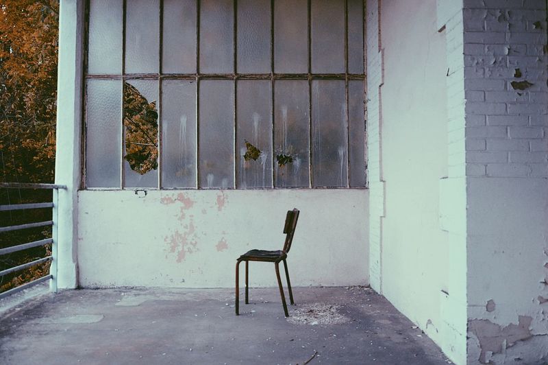 Chair by window in abandoned building