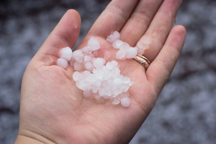 Cropped image of hand holding hailstone