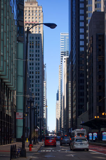 City street and buildings against sky