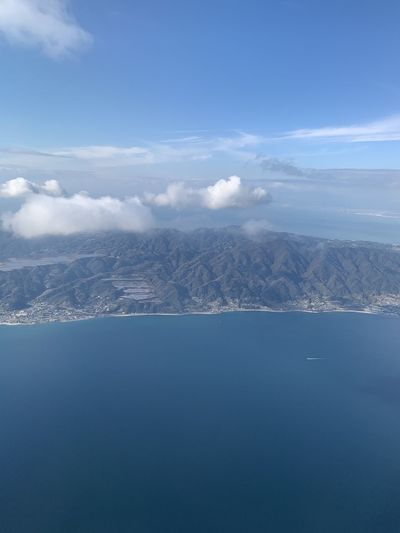 Aerial view of sea and mountain against sky