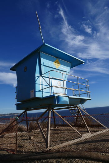 Low angle view of hut on beach against sky