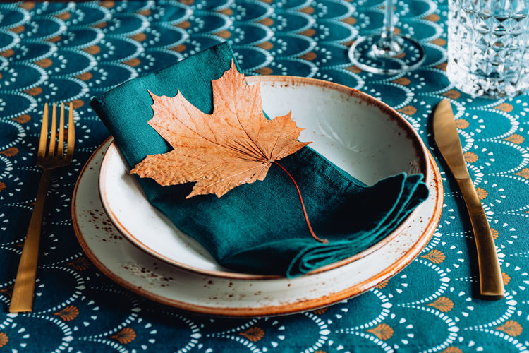 High angle view of maple leaf on table