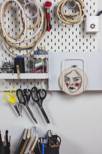 Close-up of various work tools on wall in studio