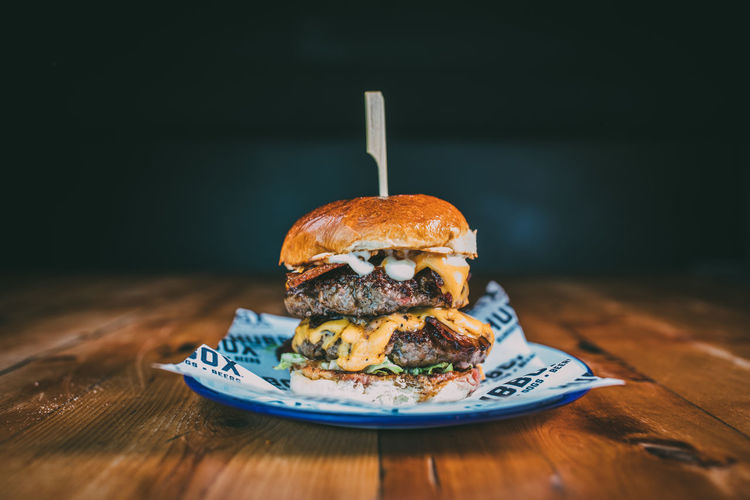 American Food Black Background Bun Burger Burger Burgers Close-up Day Fast Food Food Food And Drink Freshness Hamburger Indoors Indulgence Meat No People Plate Ready-to-eat Table Temptation Unhealthy Eating