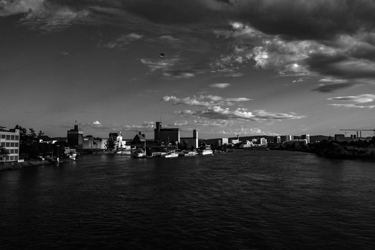 Boats in rhine river at weil am rhein against sky
