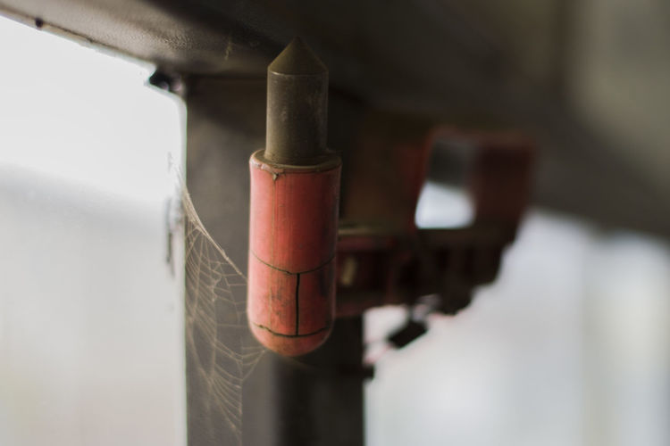 Close-up of emergency hammer hanging in bus