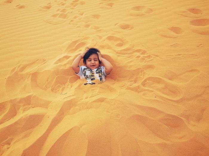 High angle view of boy in sand