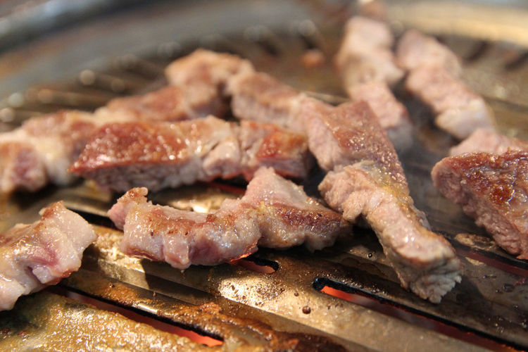 Korean grilled pork bbq or samgyeopsal-gui with charcoal at korean restaurant, busan, south korea