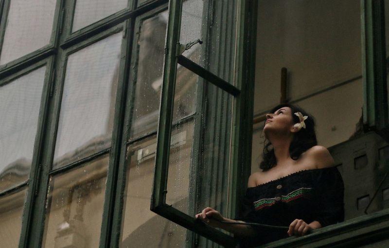 Woman looking through window