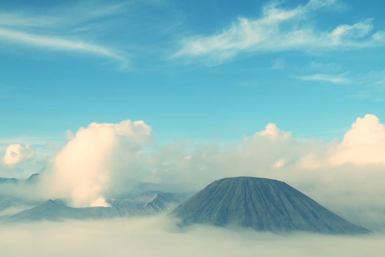 Majestic view of volcanic landscape against cloudy sky