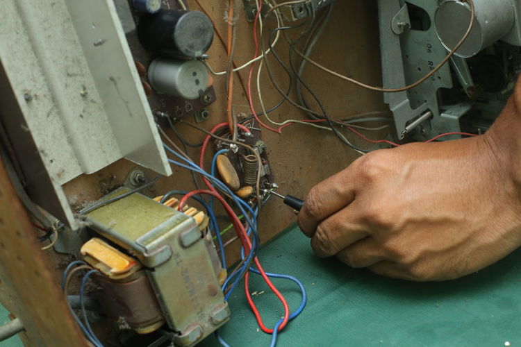 Close-up of man repairing computer chip