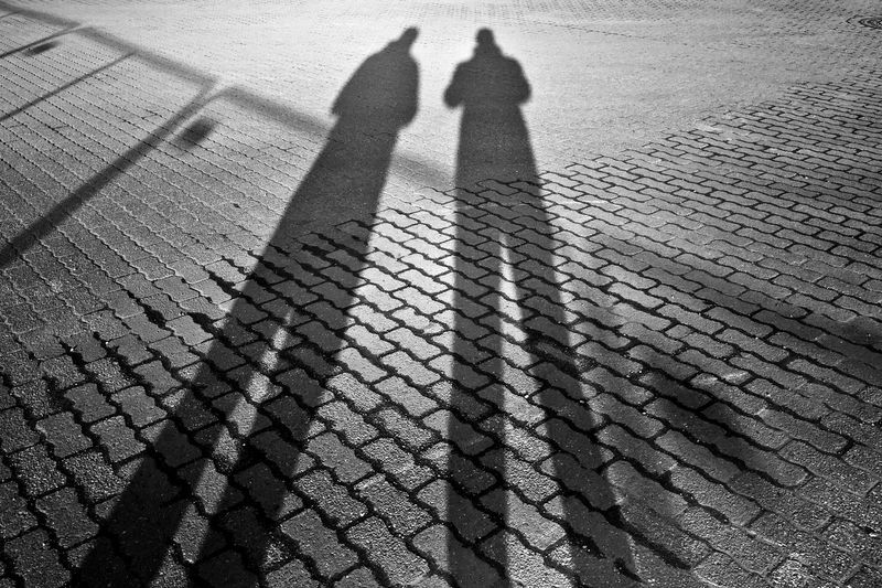 Shadow of two people on the road