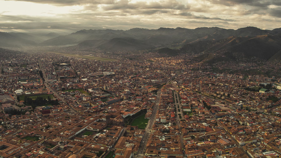 High angle view of city against cloudy sky