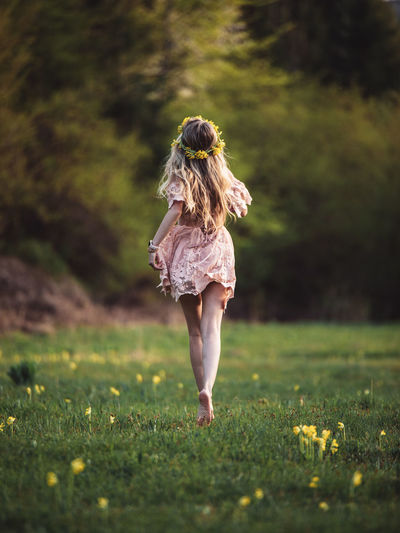 Rear view of woman standing on field