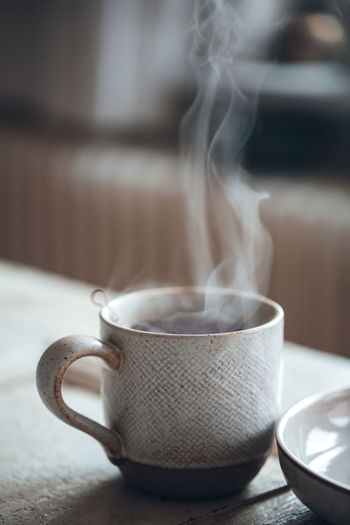 Close-up of steaming hot beverage in cup