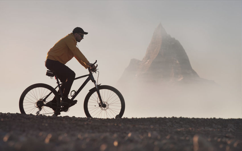 Man on a mountain bike rides in a picturesque mountainous area. active lifestyle theme