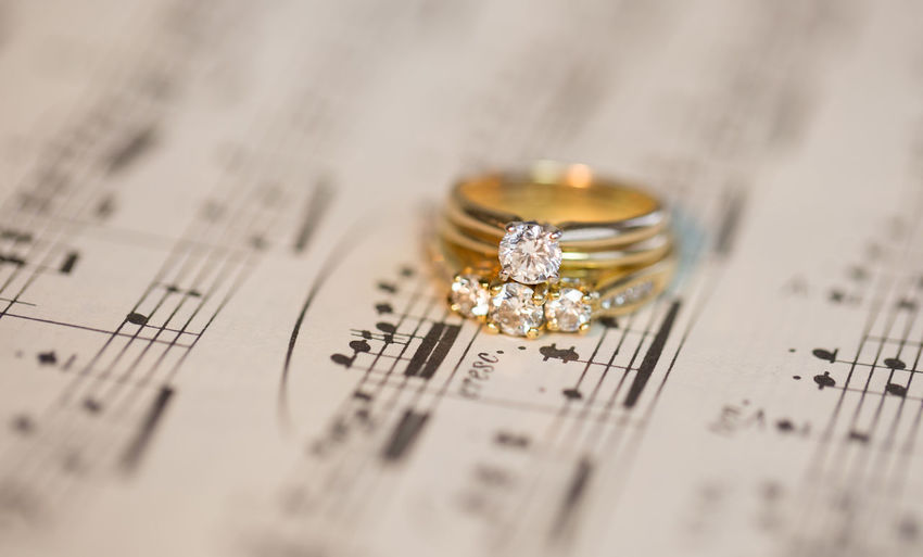 Close-up of diamond rings on musical note