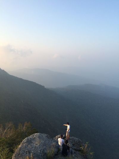 Scenic view of river in front of mountains against sky