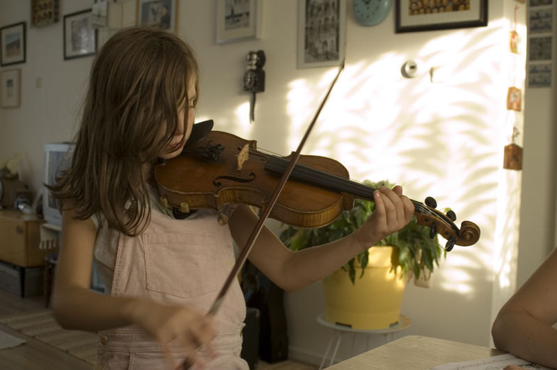 Girl playing violin at home