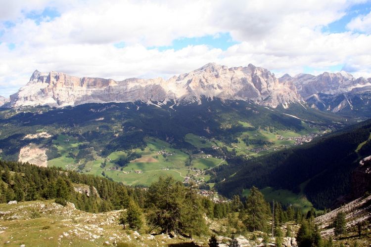 Scenic view of dolomites mountain range against cloudy sky