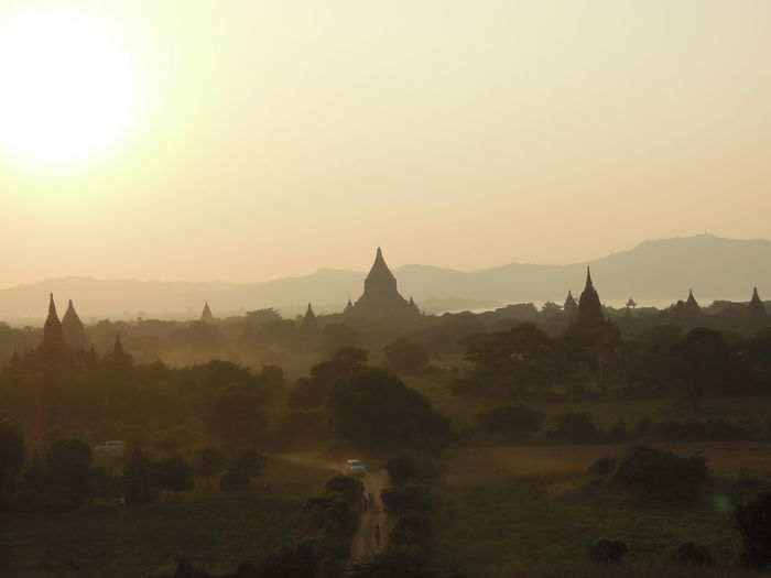 Panoramic view of temple against sky during sunrise