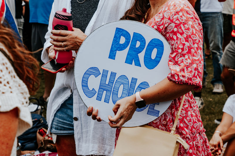 Pro choice - people march for human rights, against covid mandates, placards at peaceful protest.