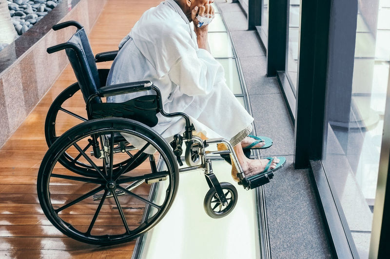 Man sitting on wheelchair at hospital