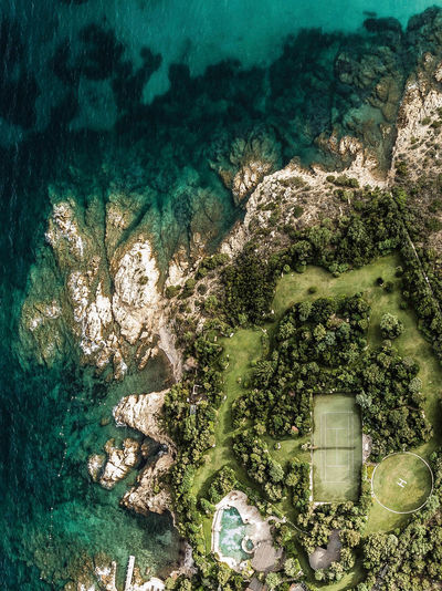 Aerial view of tennis court by sea