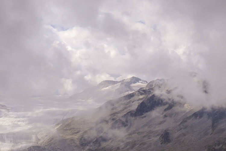 The peaks of the italian alps covered with clouds