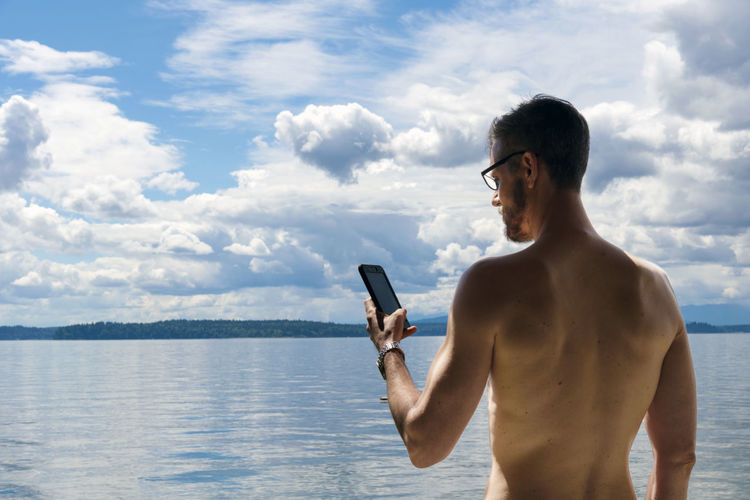 Young man using mobile phone in vacations