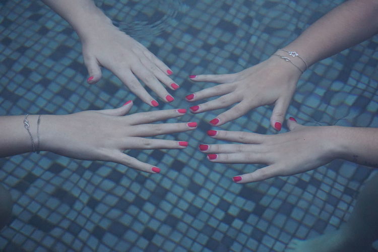 High angle view of woman hand in a pool