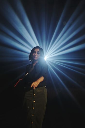 Man standing on illuminated stage
