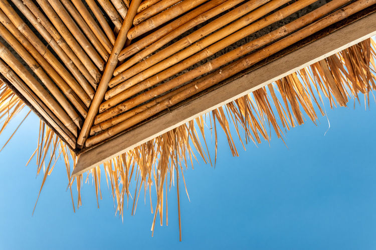 Low angle view of roof against blue sky