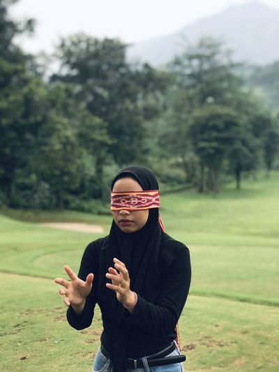 The young woman spends her time playing blindfolded