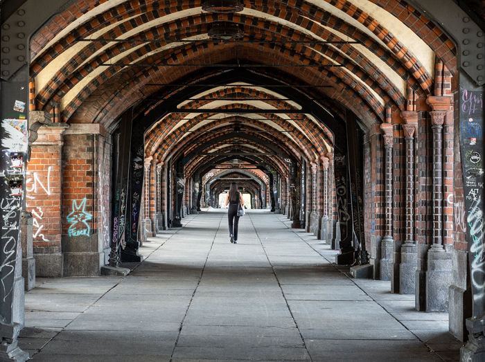 Rear view of man standing in corridor of building